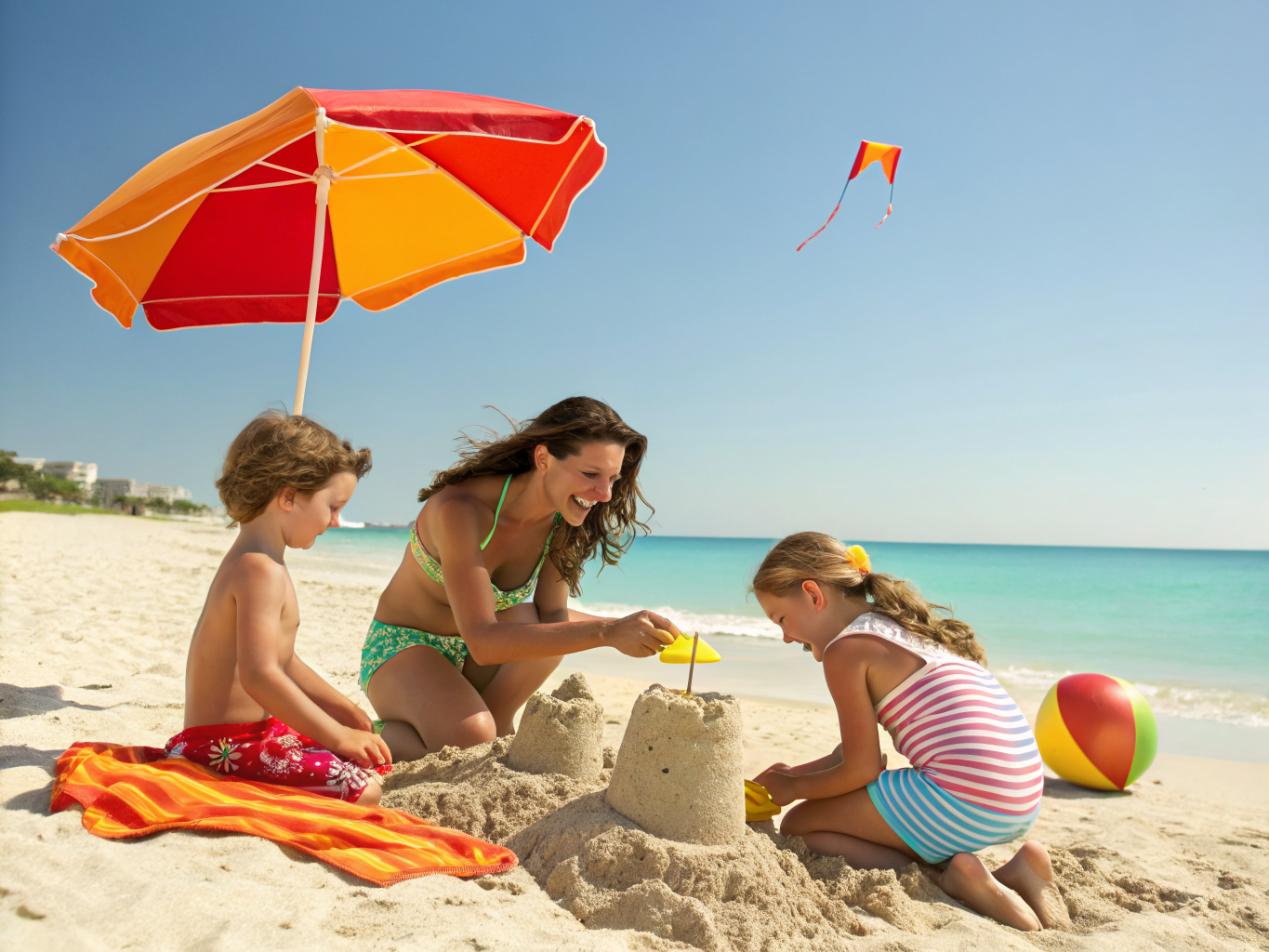 Happy single parent family playing on a sunny beach